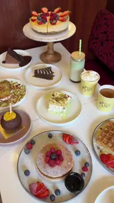 A montage showcasing a wide variety of desserts, sizzling platters, and drinks at Chai Mast, highlighting the cafe's aesthetic and menu diversity.
