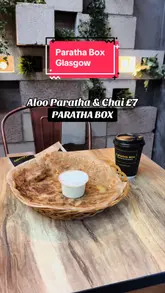 The video features a promotional offer for an Aloo Paratha and Chai combo at Paratha Box. It includes shots of the food, the restaurant's interior decor, and a quick pan of the menu board.