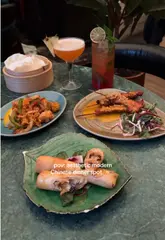 A short, aesthetic montage showcasing the interior and various dishes at Mama Yo, a Chinese restaurant. The video features slow pans of the dining area and close-ups of the food, including squid, beef, prawns, and dessert.