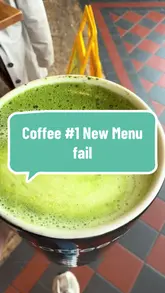 Here are a few options for your alt text, depending on the specific focus of the image:

**Option 1 (Focus on the drink):**
A creamy hot matcha latte with soy milk served in a glass at Coffee #1 in Wokingham.

**Option 2 (Descriptive):**
Close-up of a frothy hot matcha latte in a glass cup, served at a Coffee #1 cafe.

**Option 3 (Contextual):**
A steaming cup of matcha latte with soy milk held at a table in Coffee #1, Wokingham.

**SEO Tip:** I recommend **Option 1** as it includes the brand name, the specific drink, and the location, which are great for local SEO and accessibility.