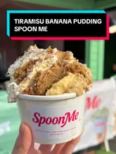 Two creators visit a street food stall called SpoonMe at the Barras Market to try a Tiramisu Banana Pudding. They provide a casual, direct-to-camera review of the dessert, sharing their thoughts on the taste and texture while standing in front of the stall.