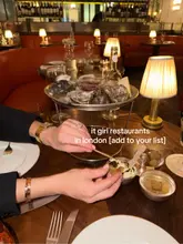 A high-quality, atmospheric shot of a premium seafood platter featuring oysters and caviar, captured in a dimly lit, upscale London restaurant setting. The image effectively conveys a sophisticated dining experience suitable for social occasions like date nights or girls' nights out.