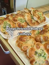 A short, engaging video tour of Fang's Oriental Bakery in Cardiff, highlighting their selection of East Asian baked goods including pineapple buns, mochi, and savory dumplings. The creator provides a brief review of the items tasted.