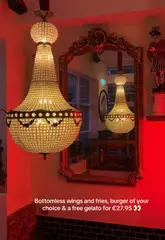 A short, fast-paced review of a restaurant offering a bottomless wings, fries, and burger deal, including a free gelato. The video features quick cuts of the venue's interior, the food items, and a cocktail, set to music with text overlays detailing the offer.