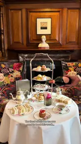 A visually stunning, polished montage showcasing a floral-themed afternoon tea at Brown's Hotel in London. The video features slow, aesthetic pans of the table setting, the venue's elegant interior, and close-ups of the sandwiches, cakes, and scones, accompanied by a champagne pour.
