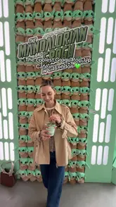 A short, energetic tour of a Star Wars-themed Grogu pop-up café in London. The video showcases the venue's interior, branded merchandise, interactive elements like a claw machine and photo booth, and themed drinks such as matcha and bubble tea.