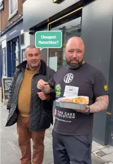 A creator reviews a 'munchbox' from BVRGRY in Nottingham, showcasing the burger, fries, and mac and cheese while standing outside the venue.