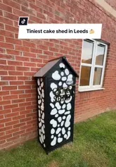 A short video showcasing a small, independent 'cake shed' in Leeds, where customers can purchase cookies and brookies. The video demonstrates the process of unlocking the shed and viewing the available treats.