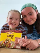 A mother and daughter prepare Old El Paso tacos at home, demonstrating the cooking process with high energy and enthusiasm.
