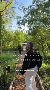 A vlog-style reel showcasing a 'Wild Table' pop-up dinner event held in a woodland setting at Browning Brothers farm. The video captures the entire experience, from the glamping accommodation and the wood-fired cooking process to the multi-course meal and evening festivities.