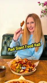 A vlog-style review of Mad Giant Food Hall in Preston, showcasing the variety of food vendors, cocktails, and the venue's atmosphere, including a photo booth and board games.