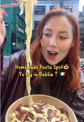 A couple visits a pasta venue in Dublin, showing the fresh pasta being made, the cheese wheel preparation, and tasting the final dish.