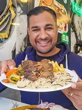 A food review video featuring a creator visiting Fishwala in Thornton Heath. The video showcases various dishes including Lahori-style grilled fish, daal chawal, chicken shawarma, a fish burger, and a lamb taco. The creator provides commentary on the flavors and quality of the food, while also showing the cooking process and the venue's interior.
