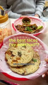 A creator visits a Salvadoran restaurant in London to review several dishes, including fried plantain with refried beans and cream, beef short rib tacos, and pork, bean, and spinach pupusas. The video features the creator's honest reactions and close-up shots of the food.