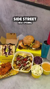 A promotional reel showcasing the food menu at the new Side Street branch in Elephant & Castle, featuring smash burgers, Japanese-style sandos, Nashville chicken, and homemade drinks.