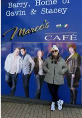 A couple takes viewers on a DIY tour of Barry Island, highlighting key filming locations from the TV show 'Gavin & Stacey', including Stacey's house, Nessa's arcade, and the seafront.