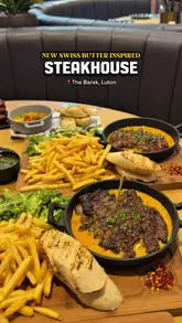 A montage-style promotional video for The Barak in Luton, showcasing a variety of dishes including steaks, burgers, and desserts, alongside cocktails and the restaurant's interior.