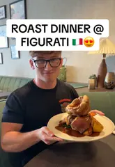 A food review video featuring a visit to Figurati in Southampton's Ocean Village. The creator samples a Bloody Mary, a baked Camembert starter, a Sunday roast with a trio of meats, and a dessert of doughnuts, providing commentary throughout.