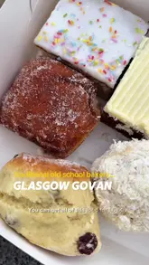A couple visits Watson's Home Bakery in Glasgow, showcasing the wide variety of traditional baked goods available at very affordable prices, including doughnuts, snowballs, and pies.