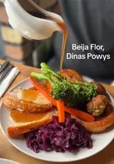 A review of the Sunday roast at Beija Flor, featuring close-ups of the roast beef, pork loin, and a vegetarian mushroom and spinach tart, alongside cocktails and the venue's interior.