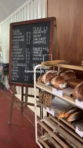 A short montage showcasing the interior, menu, and food items at Cottonrake bakery in Glasgow, including close-ups of a cinnamon bun, coffee, and sandwiches.
