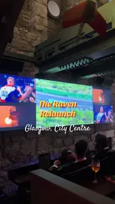 The video is a fast-paced montage showcasing The Raven in Glasgow, highlighting its suitability for watching sports. It features shots of patrons watching matches on large screens, enjoying drinks and food like wings and sliders, participating in a photo booth, and listening to live music. The editing is energetic and fits the casual, lively pub atmosphere.