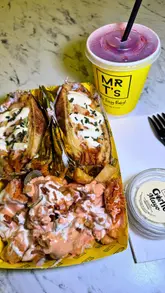 A vlog-style review of Mr T's on Wilmslow Road, Manchester, where the creator visits the venue, orders a chicken toastie and loaded fries, and provides a candid review of the experience.
