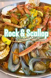 A high-energy, authentic vlog-style review of a seafood boil experience at Rock & Scallop in Newport Market, featuring two creators enjoying a messy, hands-on meal.