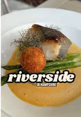 A creator reviews Riverside Social in Sarisbury Green, highlighting its impressive outdoor terrace and high-quality food offerings. The video features a mix of talking-head segments, menu shots, and close-ups of dishes like lasagna bites and pan-fried cod, set against a sunny riverside backdrop.