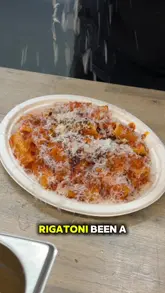 A review video featuring two creators visiting a street food stall called Fat Sal's at Common Market in Belfast. They sample the spicy vodka rigatoni, a meatball sub, and chilli cheesy garlic bread, providing their reactions to the food.