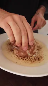 A step-by-step recipe tutorial demonstrating how to prepare a steak and cheese sandwich, featuring a homemade black garlic mayonnaise and a rich three-cheese fondue sauce.