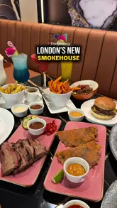 A promotional video for The Meatery, a smokehouse in London, featuring a montage of their menu items including brisket, burgers, tacos, and bone marrow, alongside shots of the restaurant's interior.