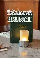 A short, polished reel showcasing a brunch visit to Lady Libertine in Edinburgh. The video features quick cuts of the venue's interior, the menu, mimosas, and several brunch dishes including a lobster brioche roll, mushroom toast, and beef brisket on sourdough.