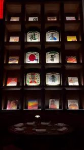 A montage of shots featuring the interior and various dishes at Mitsu, a Japanese restaurant. The video focuses on the moody, upscale atmosphere and the presentation of sushi, tempura, gyoza, grilled fish, and a matcha dessert.