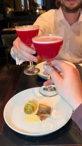 A couple enjoys a 10-course global-themed tasting menu at Six By Nico, featuring a variety of small plates, cocktails, and desserts. The video highlights the presentation of the food and the overall dining experience.