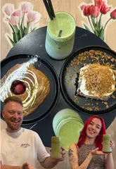 A couple visits Rasa Ko-Fee in Sheffield, showcasing their unique menu of specialty coffee, matcha, and sweet treats. They demonstrate the preparation of various drinks and taste-test items like the Biscoff sticky roll and Danish of the month.