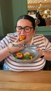 A creator visits Forage Farm Shop in Cowbridge to review their new summer menu, showcasing a variety of dishes including a scotch egg, salmon, a burger, and desserts, while also highlighting the venue's farm shop and family-friendly outdoor play area.