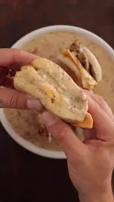A well-executed recipe tutorial for a breakfast sandwich featuring a maple bacon gravy, presented with clear steps and appetizing close-ups.