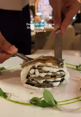 A promotional reel showcasing the opening of Nammos in Mayfair, London. The video features high-quality shots of the restaurant's interior, fresh seafood display, various dishes including sushi, Greek salad, lobster linguini, and dessert, alongside cocktails. The editing is smooth and highlights the luxury Mediterranean aesthetic.