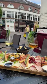 A montage of food and drink shots at an Italian wine bar, featuring close-ups of a charcuterie board, pizza, pasta, and wine, set to music.