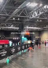 A short, energetic video capturing the atmosphere at The Hybrid Games, featuring participants in matching outfits, smoke effects, and a live saxophonist in a large indoor venue. The video highlights the high-energy, competitive nature of the event rather than a specific hospitality venue.