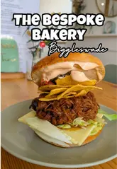 A review of The Bespoke Bakery in Biggleswade, highlighting their scratch-made cookies, iced lattes, and weekly changing menu items like the Tex Mex bagel.