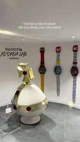 The video provides a quick tour of a free, underground watch museum located beneath the Swatch store in Covent Garden. It highlights the archival watch collection, curated artwork, and an interactive AI-DADA station where visitors can design their own watches.