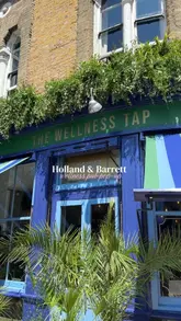 A promotional video for a Holland & Barrett pop-up event called 'The Wellness Tap,' a temporary wellness-themed pub in London featuring healthy drinks, snacks, and wellness products.