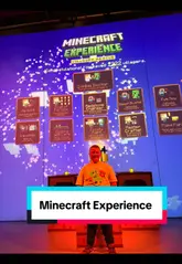 A first-person perspective video showcasing the Minecraft Experience in London, featuring interactive gameplay using a physical cube controller in a themed environment.
