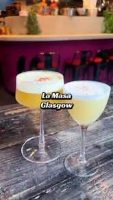 A short-form video review of La Masa in Glasgow, featuring a variety of Mexican-inspired dishes including tacos, tostadas, corn ribs, and steak, alongside cocktails. The video uses a vlog-style approach with the creator sampling the food and drinks, providing a clear look at the menu and the restaurant's interior atmosphere.