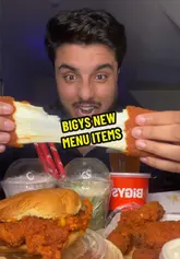 A high-energy mukbang-style video featuring a creator reviewing new menu items from Bigys, including fried chicken, a burger, mac and cheese, and various matcha drinks. The video focuses on the taste and texture of the food, providing immediate reactions and ratings.
