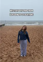 A travel vlog documenting a mystery bus day trip from Glasgow to North Berwick, featuring scenic coastal views, a visit to a local cafe, and casual dining.