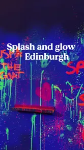 A high-energy reel showcasing a glow-in-the-dark splatter paint experience. The video features participants in protective gear throwing neon paint at canvases and walls, set to upbeat music with fast-paced editing to match the activity's intensity.