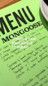 A vlog-style review of a new restaurant in Dublin called Mongoose, highlighting the menu and specific dishes like the whole chicken and Caesar salad.
